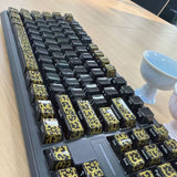 High-temperature firing of black and gold-patterned ceramic keycaps