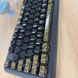 High-temperature firing of black and gold-patterned ceramic keycaps